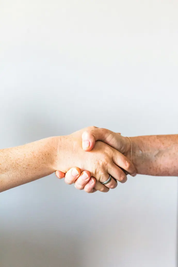 person holding hands of another person